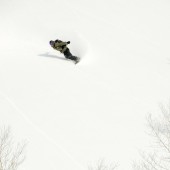 Jamie Thompson flying in the Niseko Backcountry